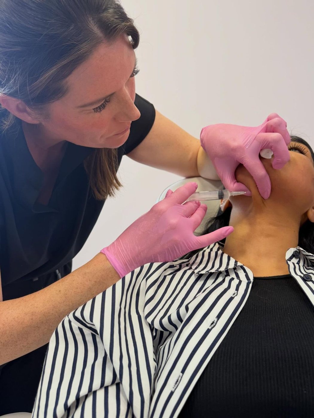 A precision treatment being carried out along the cheek